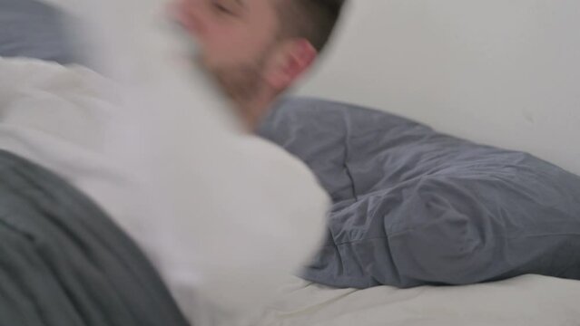 Man Waking up from Sleep in Bed