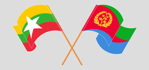 Crossed and waving flags of Myanmar and Eritrea