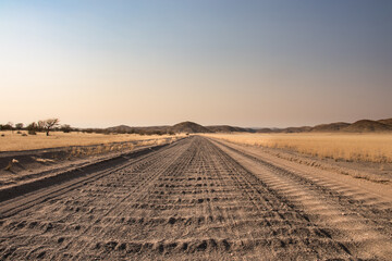 Roadtrip in Damaraland, Namibia. Close up of a washboard gravel road in Namibia - obrazy, fototapety, plakaty