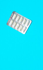blisters with white pills on a blue background