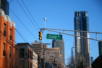 Green big Grove Street sign hanging on a arch pole in the streets of downtown Jersey City