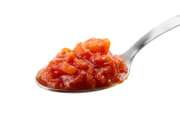 Chopped tomatoes in tomato juice in spoon isolated on white