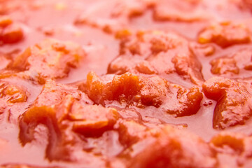 Chopped tomatoes in tomato juice food background