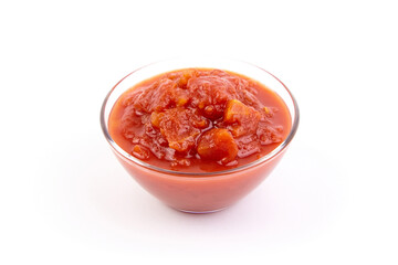 Chopped tomatoes in tomato juice in glass bowl isolated on white