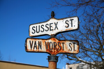 Historical, traditional and rust Sussex Street and Van Vorst Street iron sign in Paulus Hook