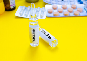 ampoule vaccine on yellow background