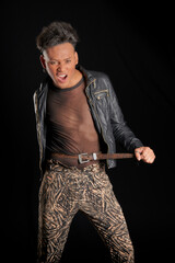 Latin man dressed in transparency and leather jacket, adjusting his belt