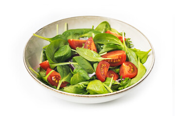 Summre green salad in white bowl plate on grey table