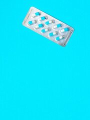 blisters with blue pills on a blue background