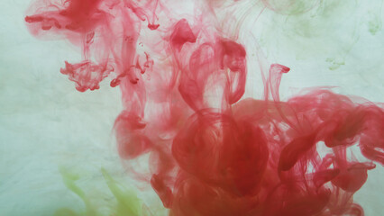 Red paint in the water. abstract background. ink in fluid. colorful splashes in liquid