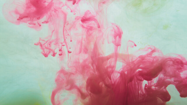 Red paint in the water. abstract background. ink in fluid. colorful splashes in liquid