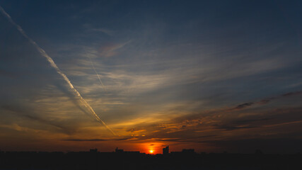 Fototapeta na wymiar Golden sunset over the city. evening cityscape