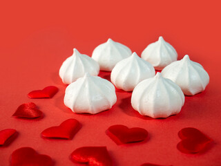 Traditional French Meringue dessert. Gentle kiss of meringue. On background with hearts on Valentine's Day, Mother's Day
