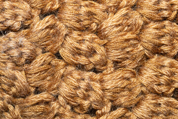 Knitted woolen background. brown soft fabric close up