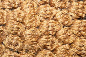Knitted woolen background. brown soft fabric close up