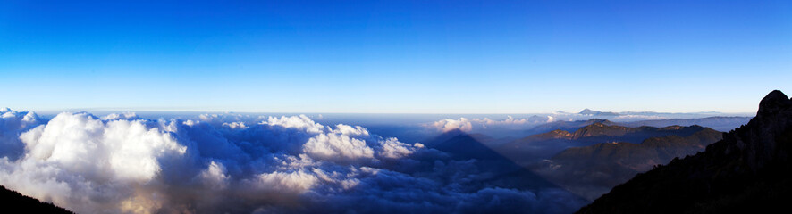 Panorama of Santa María Volcano, a large active volcano in the western highlands of Guatemala casting shadow on surrounding mountains.