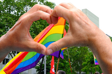 members of LGBTq movement, Gay pride parade in city with rainbow flags, demonstration of people,...