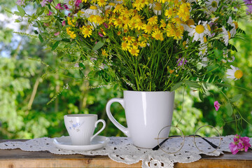 cup of tea, beautiful summer bouquet of wildflowers, handmade lace white doily on the table, summer...