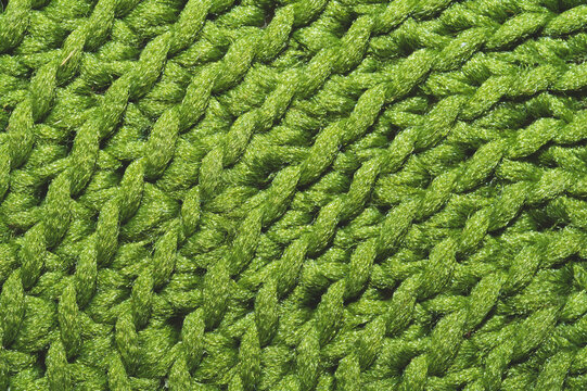 Knitted background close up. green woolen fabric