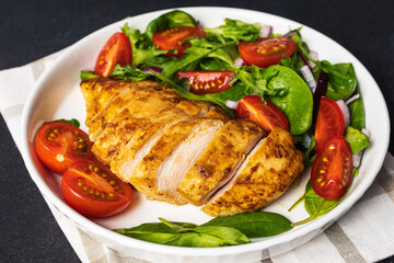 Grilled chicken breast with geen salad from fresh vegetable salad