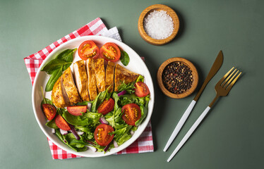 Grilled chicken breast with geen salad from fresh vegetable salad