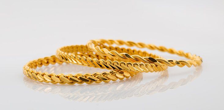 Gold jewelry. Gold bangle on background