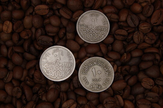 Old arab coins on coffee beans background