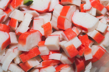 Crab sticks pieces close up background. Salad ingredient