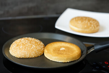 toasting buns on pan. grilled burger buns. close up