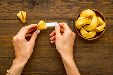 Female hands holding Chinese New Year fortune cookie. Good luck concept