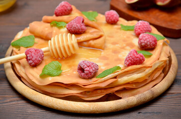 still life with pancakes decorated with berries for Shrovetide, selective focus