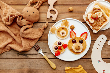 Animal Shaped Pancake with strawberry and fruit for kids. Plate with funny pancake. Funny breakfast idea for children. Kids meal. Flat Lay