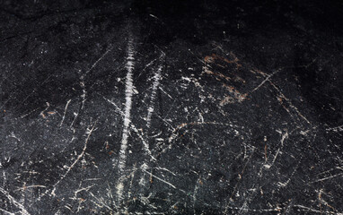Black metal texture with scratches. For use as a background or texture.