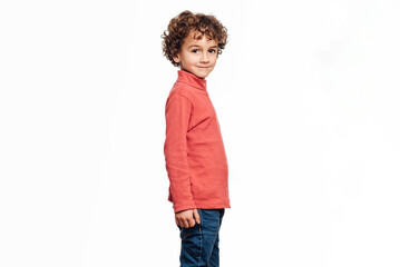Young boy looking at camera and smiling while posing over an isolated white background. Childhood concept.