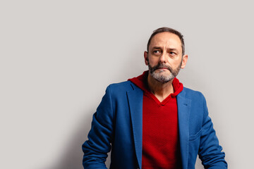 Portrait of sexy mature grey bearded man. Stylish bearded senior bearded man looking away from camera isolated on grey background.