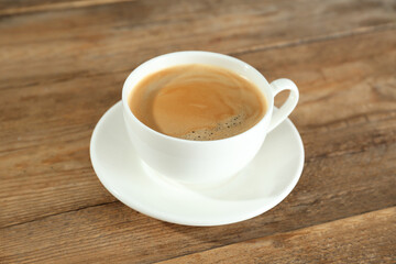 Cup of tasty coffee on wooden table