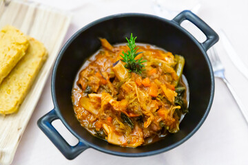 Cassoula with polenta. Meat on the bone with stewed vegetables