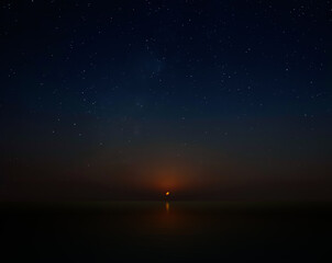 Crescent Moon setting over calm waters