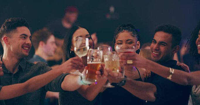 Young diverse friend group happy smiling toasting having fun drinking holding glass at a party at a club.
