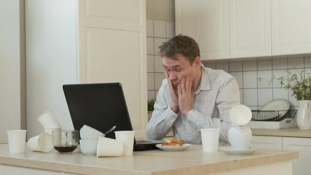 Tired Male Freelancer Overwhelmed with Job, Using Laptop All Night Long. Drinking from Coffee Pot. Working Overtime, Remote Work and Freelancer Lifestyle Concept