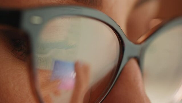 Woman shopping online, reflection in glasses of the hands and credit card making e bank online payment. Ecommerce website payments concept.