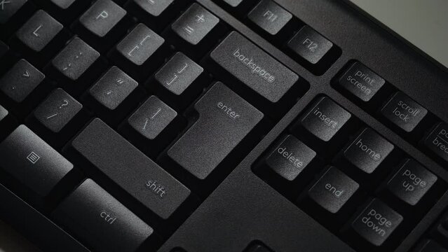Hitting the Enter key on a desktop pc keyboard. Close up shot with finger presses a computer key. Enter key mean digital confirmation, sending message. Detail of Enter button.