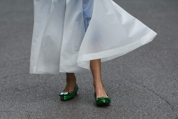 woman wearing shiny dark green shoes and white transparent dress