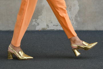 woman wearing persian orange pants and golden shoes