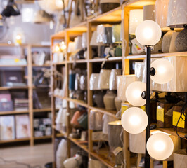 Fototapeta na wymiar Closeup of variety stylish electric lamps at shelf at a decor store