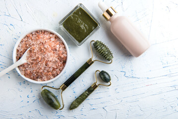 Lotions and face masks. Jade massage roller. Cosmetic procedures for skin care. Salt for spa treatments.