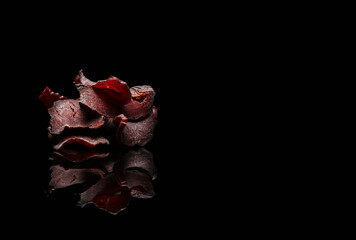 Spicy beef jerky on dark background