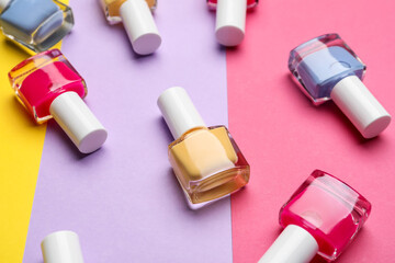 Set of nail polish bottles on color background