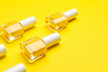 Nail polish bottles on color background