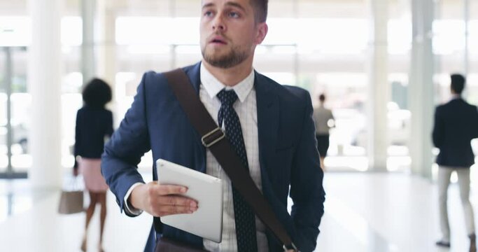 I hope I make it in time. Young businessman running in a hurry to a meeting, appointment or interview. Caucasian man arriving late and rushing for time while holding digital tablet device in an office